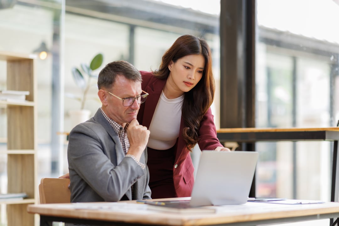 Two people at computer thinking