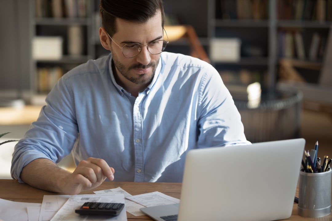 Guy at desk with calculator